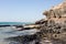 Black rocks of Costa Calma beach. Blue coastline. Playa Barca, Fuerteventura, Canary islands, Spain. Istmo de la pared