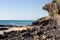 Black rocks of Costa Calma beach. Blue coastline. Playa Barca, Fuerteventura, Canary islands, Spain. Istmo de la pared