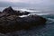 Black rocks and swirling surf at Pfeiffer Point, north of Big Sur, California
