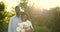 Black romantic couple with peony bunch in rural setting