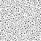 Black round spots scattered on white background. Seamless pattern. Irregular polka dot.