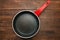 Black round teflon non-stick pan on table