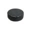 Black rubber hockey puck isolated on white background