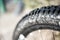 Black rubber tyre of a muddy mountain bike