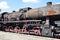 Black rusty vintage steam train on a platform