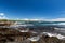 Black Sand Beach, Big Island, Hawaii. Volcanic rocks in foreground; ocean, waves and coastline in background.