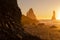 Black Sand Beach In Iceland. Sunset over Volcanic Cliffside. Stunning Ocean Coast. Unusual Mountain in Pure Nature