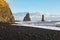 Black sand beach with ocean waves and Reynisdrangar rocks at winter, Iceland