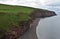 Black Sand Beach with Red Rock Sea Cliffs in England