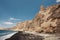 Black sand beach with wind carved cliffs