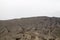 black sand on the wall of bromo volcano with the step for tourists to go to the top