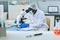 Black scientist using microscope in laboratory