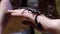 Black Scorpion sitting on hand. Action. Close-up of large black Scorpion on man`s arm. Courage of holding dangerous