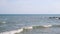 Black Sea coast with large stones, waves splashing around on a sunny summer day, Black Sea