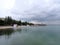 Black Sea coast, seascape, distant shore, cloudy weather, building on the seashore, calm water