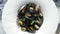 Black seafood spaghetti pasta with mussels over stone background. Mediterranean delicious food