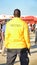 Black security guard wearing yellow jacket