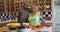 Black senior couple hugging and smiling at camera in kitchen