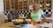 Black senior couple smiling at camera in kitchen