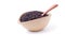 Black sesame in oval light brown bowl and wooden spoon