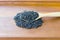 Black sesame seeds in wooden spoon pile