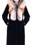 Black sheepskin fur coat with fox collar isolated on grey background. Fur coat on model without face. Outerwear. Cloth.