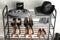 Black shelving unit with shoes and accessories near white wall