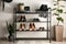 Black shelving unit with shoes and accessories near white wall in hall