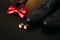 Black shoes of the groom, red bow tie, cufflinks, belt, on a bla