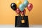 Black shopping bag paired with an array of vibrant, floating balloons