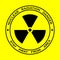 Black sign for nuclear radiation on yellow background