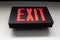 Black sign that reads EXIT in red letters