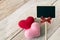 Black sign stick with pink and red hearts. Minimal and simple love photo concept