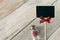 Black sign stick with red rose in tiny bottle glass. Minimal and simple love photo concept