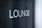 Black sign to lounge room in airport.