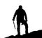 Black silhouette of climber with ice axe in hand