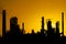 Black silhouette of crude oil refinery station during sunset