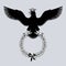 Black silhouette of an eagle in crown with outstretched wings holding a laurel branch