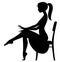 Black silhouette of fine girl in dress seated half-face on the c