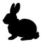 Black silhouette of fluffy rabbit or hare sitting isolated on w