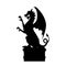 Black silhouette of gothic statue of dragon. Medieval architecture. Side view of stone cathedral sculpture