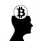 Black silhouette of human head with sign of bitcoin inside isola