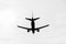 Black silhouette of a landing plane
