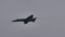 Black silhouette of a modern military fighter jet in flight in slow motion