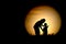 The black silhouette of Mom and kids watching the moon