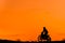 Black silhouette Motocross rider on a motorcycle in front of colorful sunset