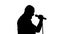 Black silhouette of a singer vigorously singing on