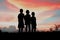 Black silhouette of three children standing together.