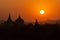 Black silhouettes of temples and trees at sunset at Bagan