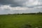 Black and Silver Color Clouds during monsoon with Green Landscape